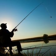 Young man fishing on a lake